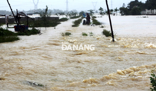 Một tuyến đường liên thôn ở xã Hòa Tiến bị lũ chảy cắt qua.