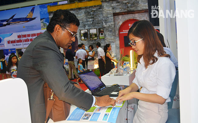  An employee from a local tourism business introducing its products to a foreigner during a recent tourism fair