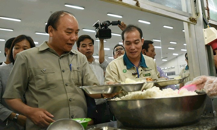 Thủ tướng cùng các công nhân lấy suất cơm ca chiều (Ảnh: Chinhphu.vn)