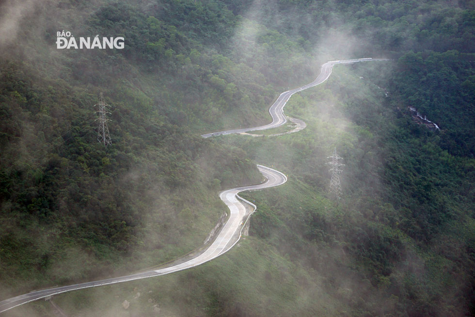 An amazing view of scenic and zigzagging road along the pass being engulfed in fog 