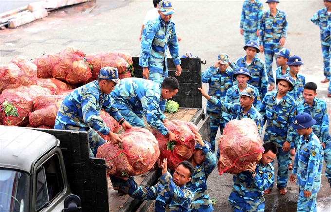 Soldier santa: Soldiers of brigate 146 carry gifts and necessities aboard. — VNA/VNS Photo Quang Quyết Read more at http://vietnamnews.vn/life-style/421167/tet-gifts-from-the-mainland-arrive-at-truong-sa-island.html#PYxsihvuqSCBvfhZ.99