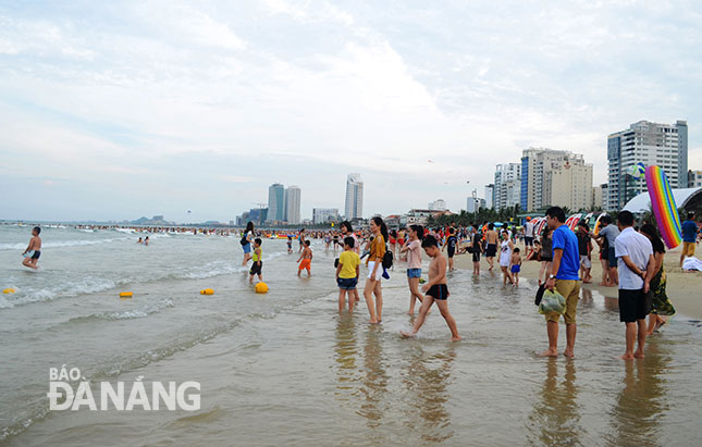  A local beach is crowded with swimmers