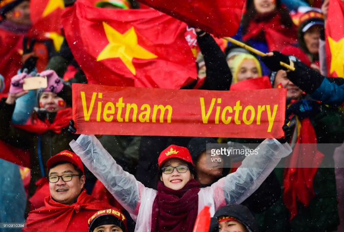 A large number of Vietnamese fans cheering for the team