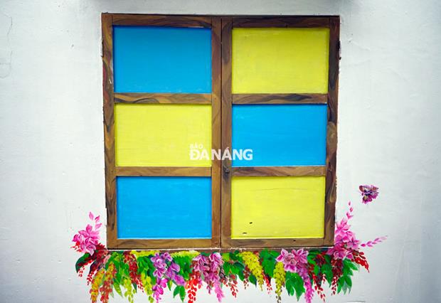An old window is covered with brilliant colours