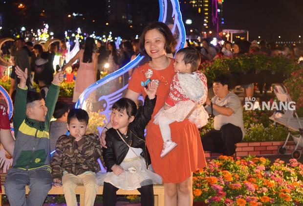 A family members taking a photo at the Bach Dang colourful flower street