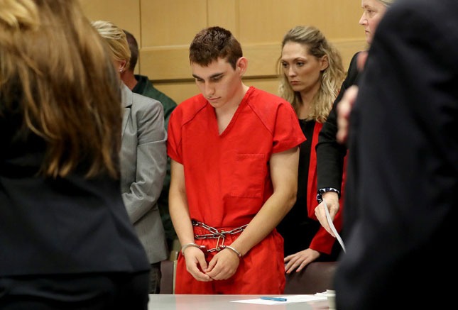 Nikolas Cruz, nghi can xả súng tại Trường trung học Marjory Stoneman Douglas, cúi đầu khi  ra tòa. 							                                 Ảnh: Reuters