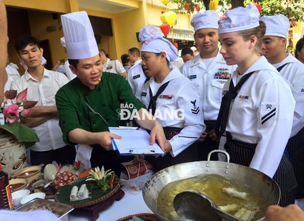  A local chief (in green T-shirt) teaching the US crew members how to make ‘nem ran’