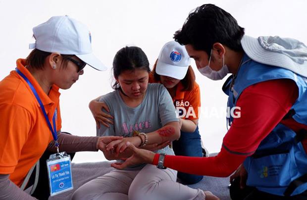 Meanwhile, an EMT from Indonesia providing first aid for a victim with severe burn injuries