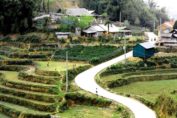     A concrete path curves around terraced fields