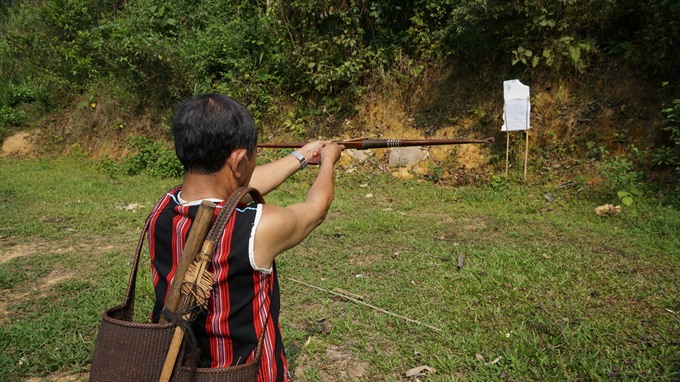 On guard: A man demonstrates cross-bow shooting. — Photo courtesy Rose Travel Read more at http://vietnamnews.vn/life-style/425459/co-tu-cultural-day-to-stage-in-da-nang.html#vItJQ08EACHbaOYk.99