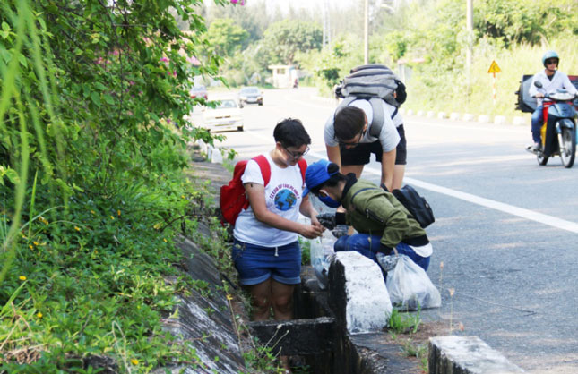 Khách nước ngoài tham gia nhặt rác đoạn đường lên chùa Linh Ứng Sơn Trà. 