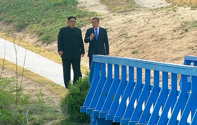 Tổng thống Hàn Quốc Moon Jae-in (phải) và nhà lãnh đạo Triều Tiên Kim Jong-un cùng đi bộ tại làng đình chiến Panmunjom. (Nguồn: Yonhap/TTXVN)