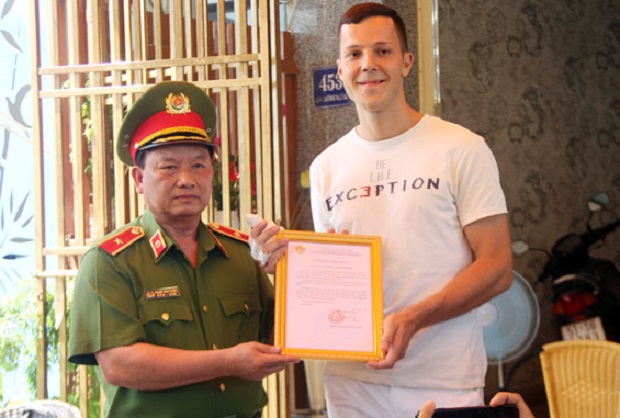 A representative from FPFRPD (left) representing a certificate of Merit from his department to Mr Valeria