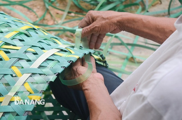  The skilled man is weaving a basket