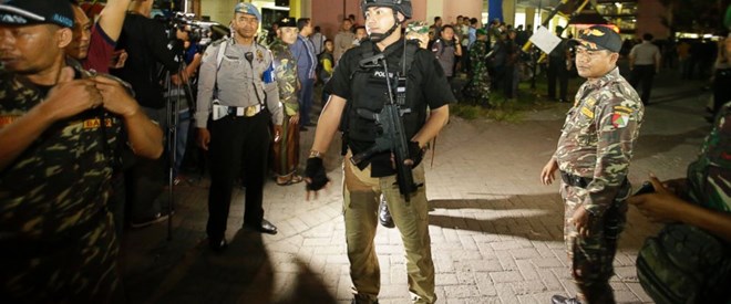 Indonesian police stand guards in front of a flat after an explosion in Sidoarjo, East Java, Sunday, May 13, 2018.(Source:https://abcnews.go.com)