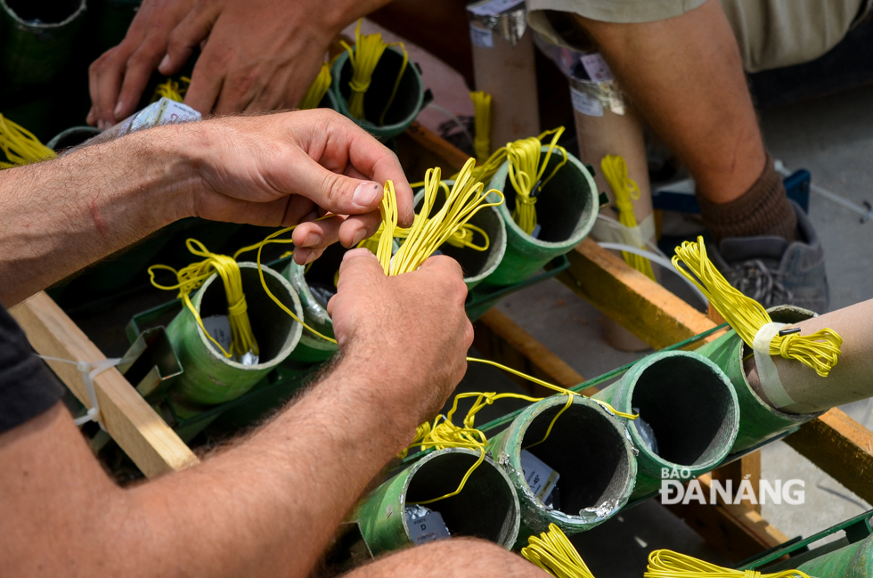 French team members carefully preparing the fireworks