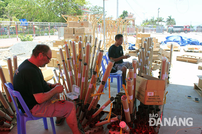 French team members carefully preparing the fireworks