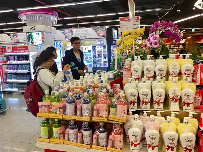 Customers shop for personal care products at a supermarket in HCM City 