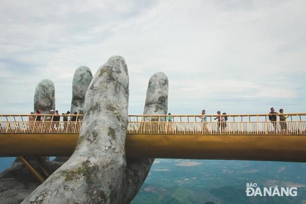 The bridge is supported by giant hands 