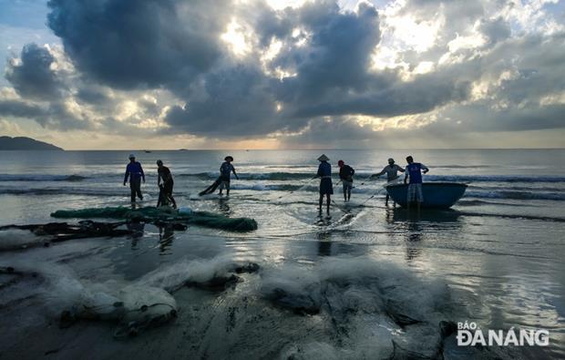 Local fishermen pulling in fishing nets in an early morning