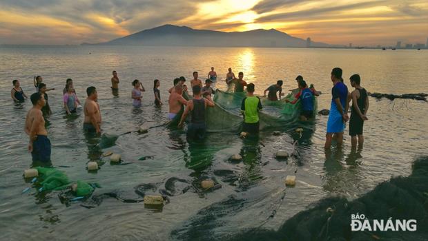 The first fishing netting full of fish and shrimps