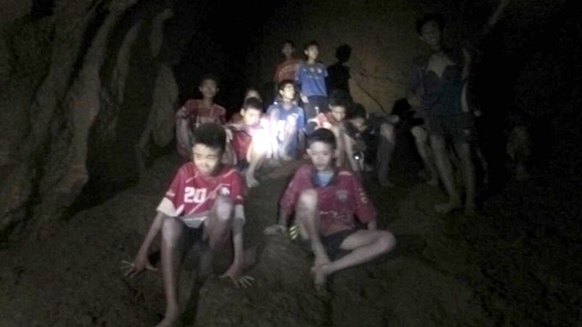 The cave-trapped boys and their football coach when they are found (Photo: AFP/VNA)