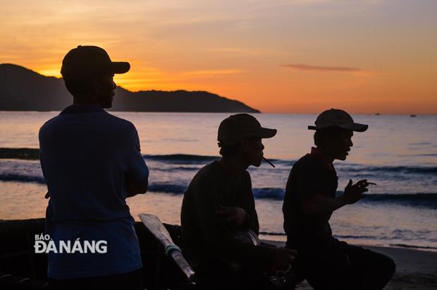 Fishermen smoking after pulling their fishing net in an early morning  