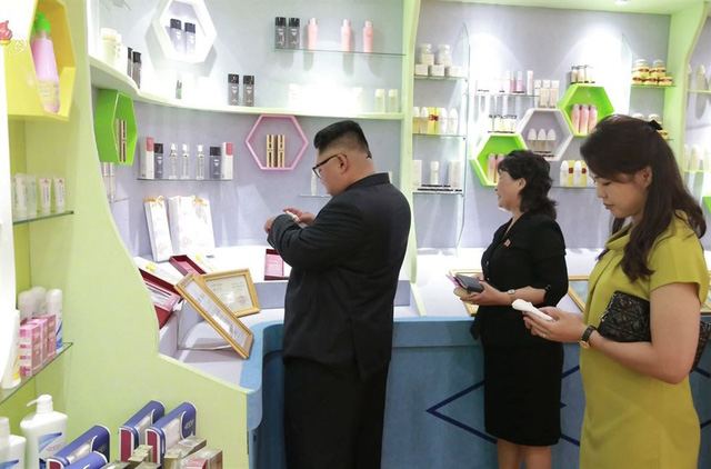 Khi tới thăm nhà máy mỹ phẩm Sinuiju, ông Kim Jong-un đã cùng phu nhân thử chất lượng của mỹ phẩm tại đây. Đệ nhất phu nhân Triều Tiên Ri Sol-ju (góc phải) cũng tháp tùng ông Kim Jong-un trong chuyến thị sát này.