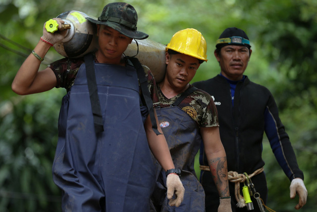 Các binh sĩ vận chuyển bình oxy tới hang Tham Luang (Ảnh: Reuters)