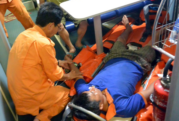  the sick crew member receiving first aid from doctors onboard rescue ship SAR 412