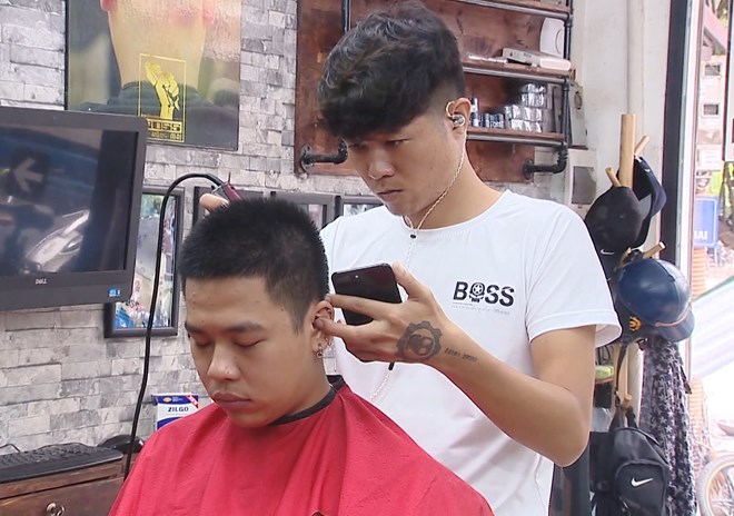 Barber Nguyen Dzung has his own way to enjoy World Cup 2018 (Photo: VNA)