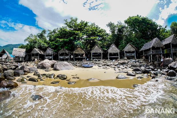 Several palm leaf huts are built on large stones in Bai Rang