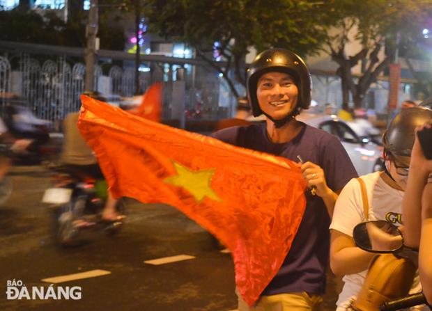 A fan waving the Vietnamese flag to celebrate the quarterfinal victory  