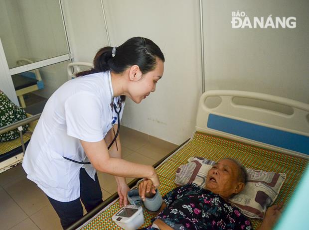 An old woman being is being provided with medical examination by a staff member of the care centre for those who gave great service in the national revolution