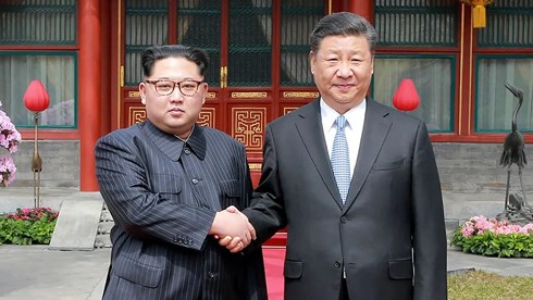 Nhà lãnh đạo Triều Tiên Kim Jong-un bắt tay Chủ tịch Trung Quốc Tập Cận Binh trong chuyến thăm Bắc Kinh ngày 27/3/2018. (Ảnh: AFP)