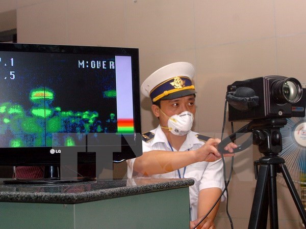 Measuring body temperature at Ha Noi's Noi Bai International Airport 