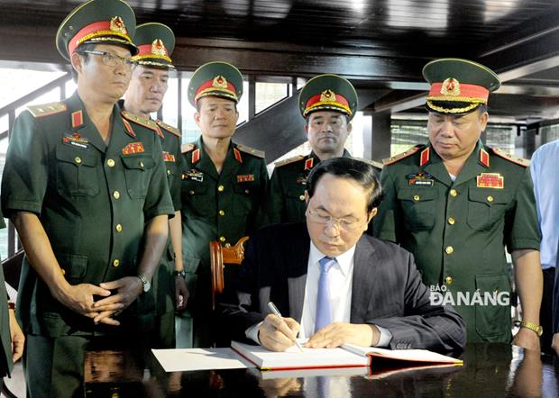 The late President writing in a guestbook at the Museum.