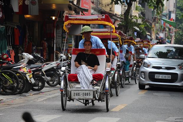 Passenger taking cyclo tour to sightseeing the old quarter.                                                 