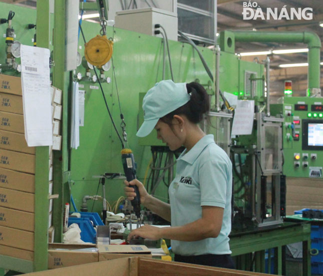 It is an urgent need to foster the professionalism of the local labour force to attract more foreign investors to the city. A worker (pictured) on her working shift at the Tokyo Keiki Precision Technology Company at the Da Nang Hi-tech Park