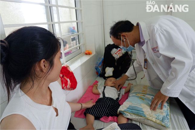 A doctor giving medical examination to a child patient
