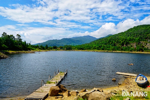 The lake is surrounded by forests and mountains. 