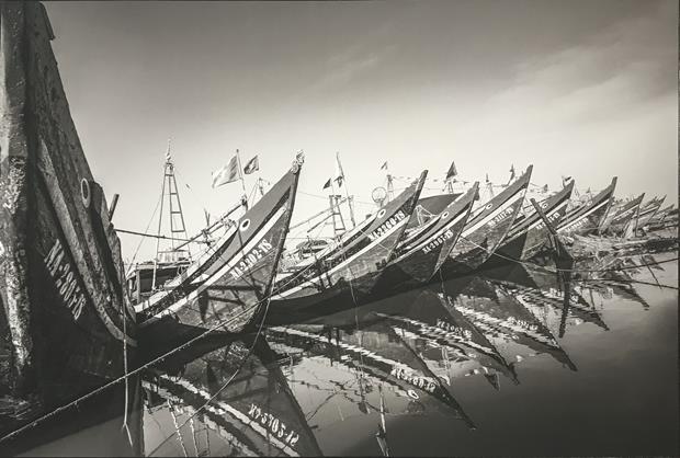 Fishing boats being anchored at a fishing wharf