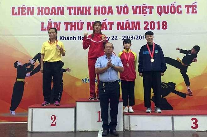 Ai Van (standing on podium No 1) during an awards ceremony for winners in the First International Vietnamese Martial Arts Festival in March 2018