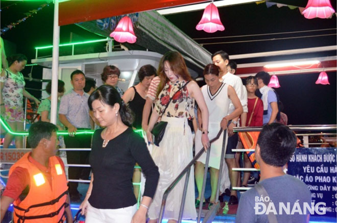 Passengers getting off a tourist boat after finishing their tour on the Han River