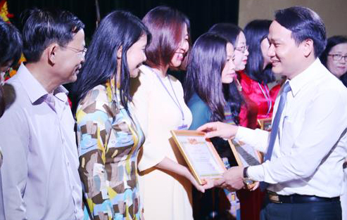 Thành ủy viên, Giám đốc Sở GD&ĐT Đà Nẵng Nguyễn Đình Vĩnh (bên phải) trao giấy khen cho các giáo viên có thành tích xuất sắc năm học 2017-2018- Ảnh Thanh Tình