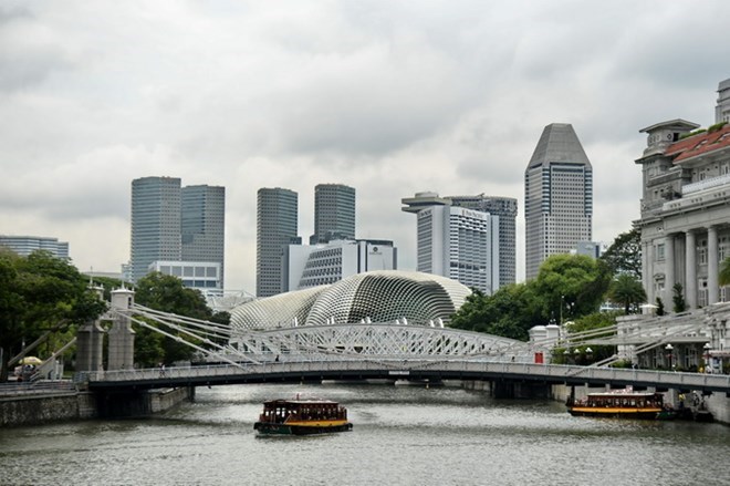 Singapore is expected to report slower third-quarter economic growth than initially thought (Photo: AFP/VNA)