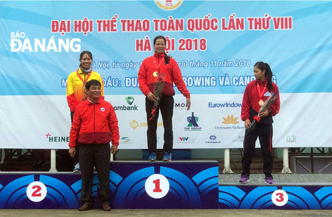 Local rower Pham Thi Hue (standing on podium No 1) during an awards ceremony for winners in the heavyweight women's single sculls event