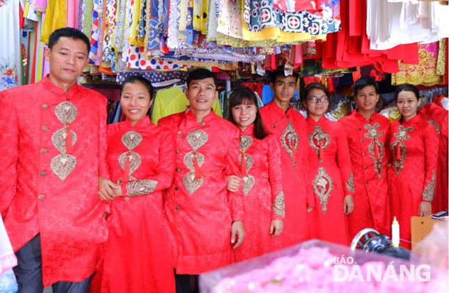 The couples trying on wedding costumes to prepare for their upcoming collective wedding ceremony.