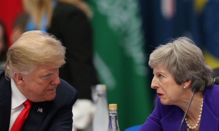 Thủ tướng Anh Theresa May (phải) trông có vẻ căng thẳng khi nói chuyện về một vấn đề gì đó với Tổng thống Mỹ Donald Trump.