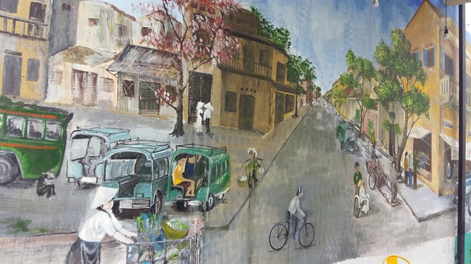 Hustle and bustle: A painting of a street in Đà Nẵng. — VNS Photo Công Thành Read more at http://vietnamnews.vn/sunday/480830/painting-team-brighten-up-cafes-in-da-nang.html#526RGlR6vLvJjLuP.99